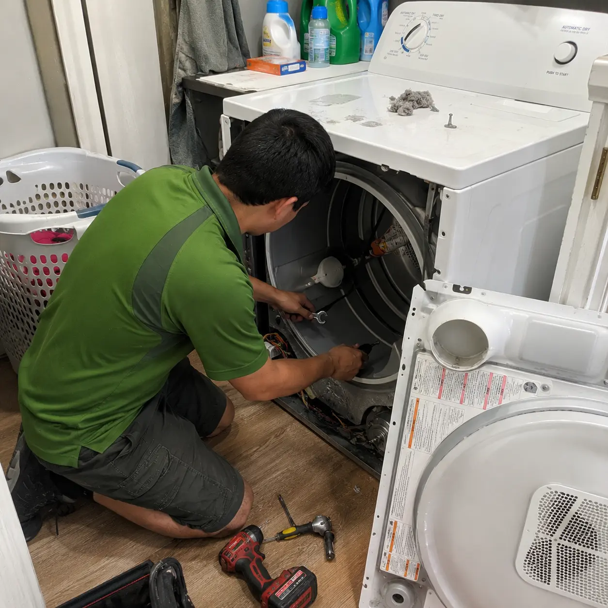 Greenergy Air technician repairing a residential clothes dryer during a professional appliance repair service