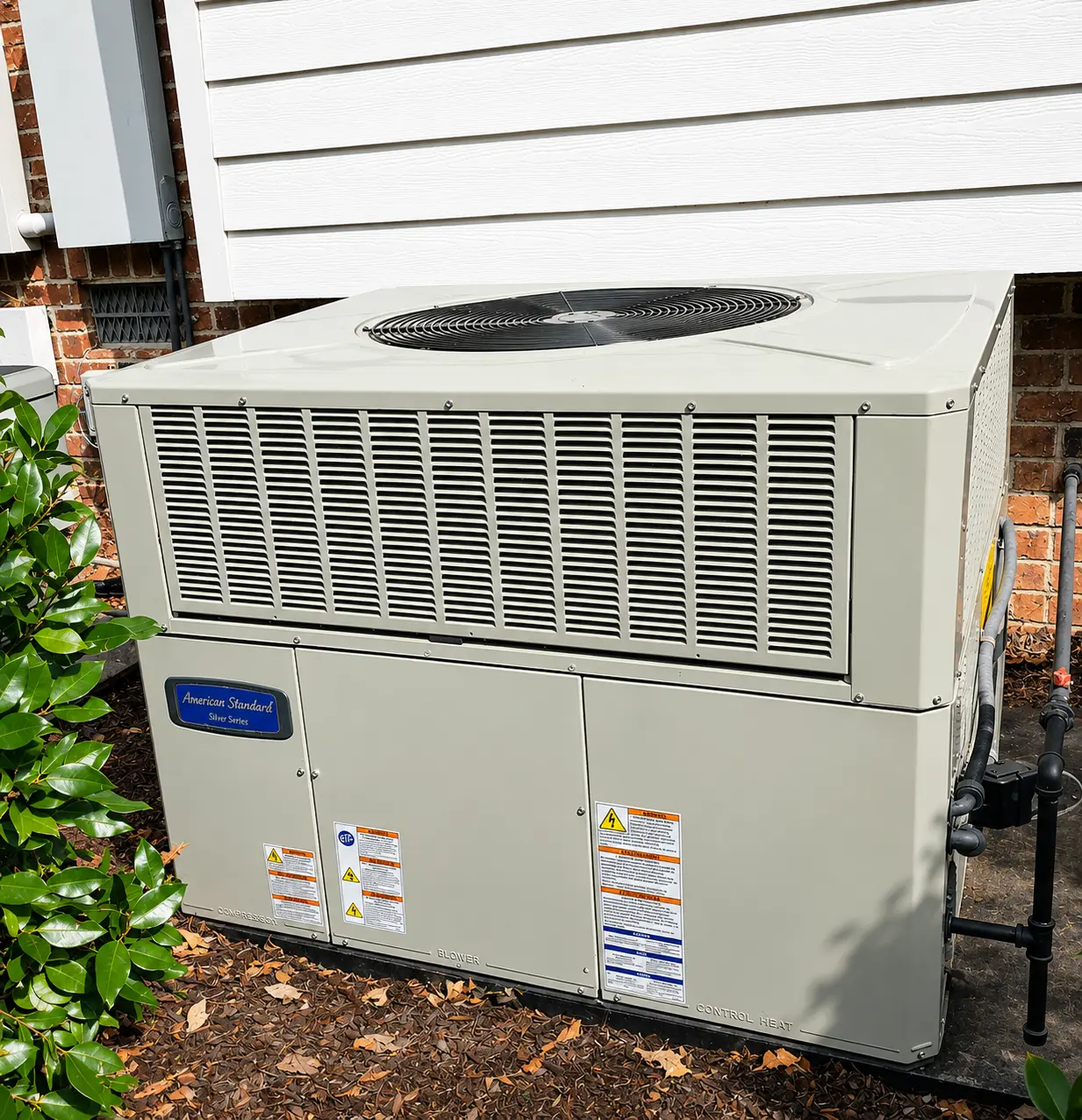 Outdoor residential HVAC condenser unit installed beside a home for efficient heating and cooling performance