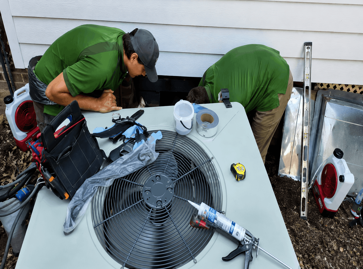 Technicians working on HVAC system