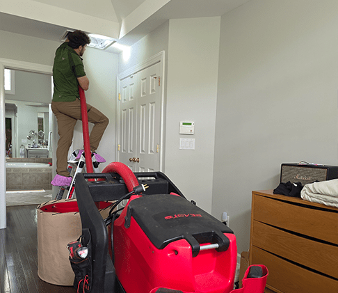 Technician performing residential air duct cleaning service