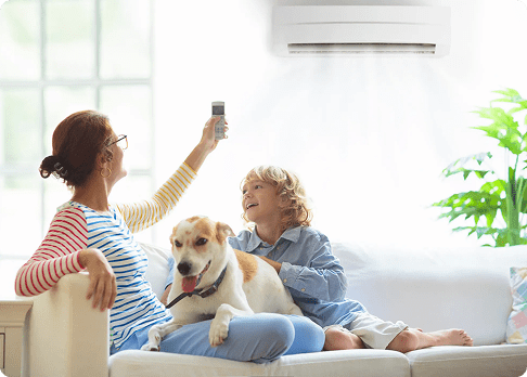 Family enjoying cool indoor air from wall mounted HVAC system