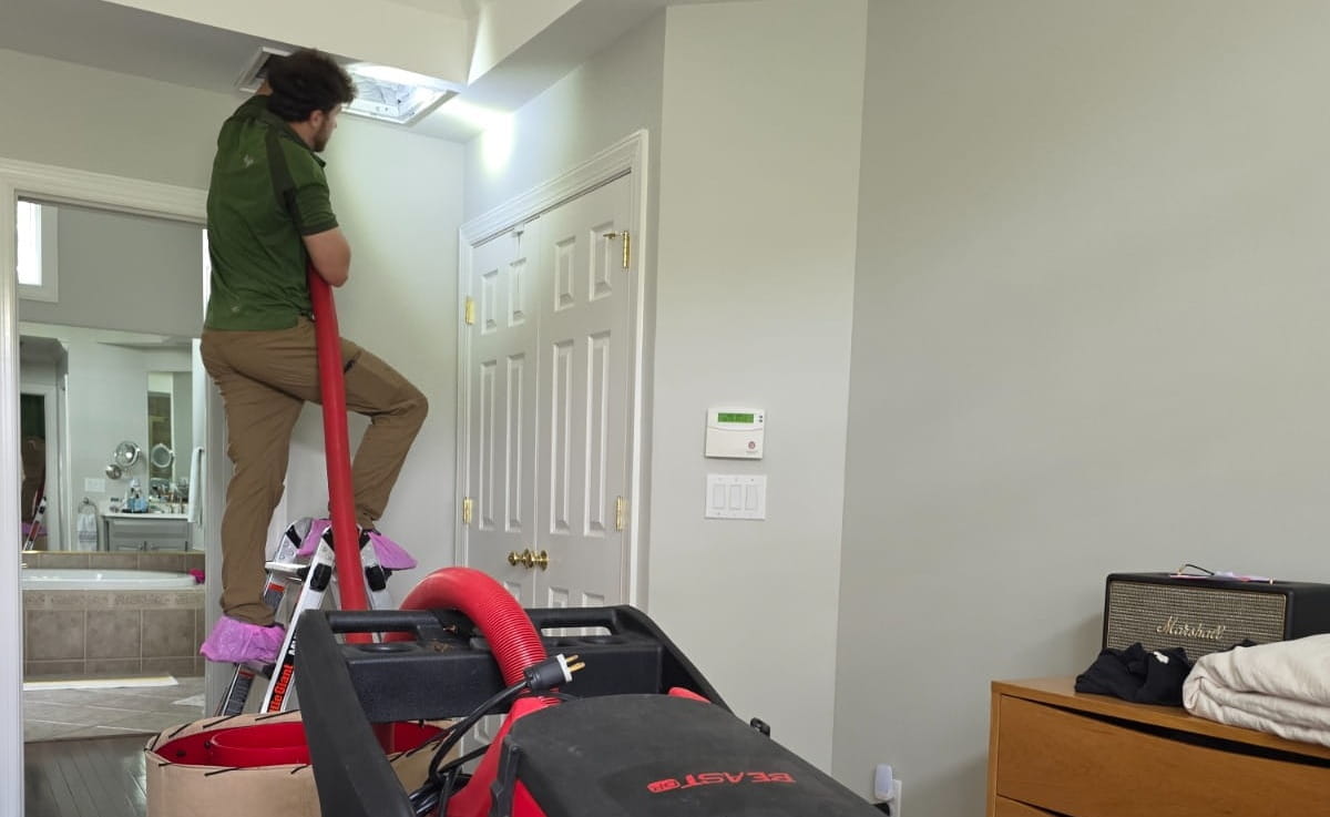 Professional HVAC duct cleaning technician at work